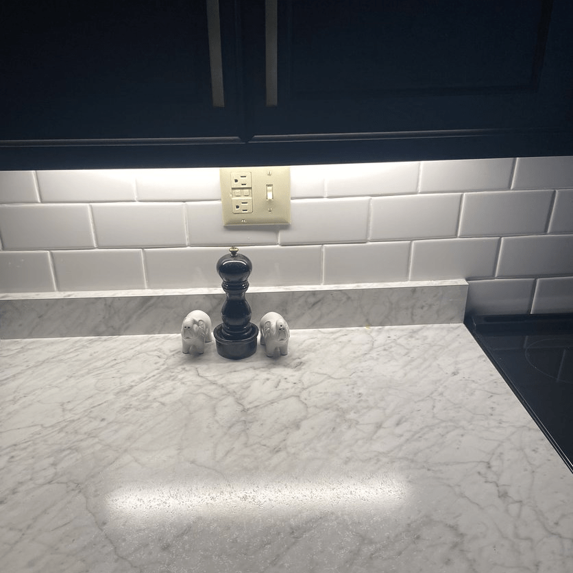 View of my countertop illuminated by a bright light that is affixed to the base of my cabinet. The space is very bright where I would be prepping food.