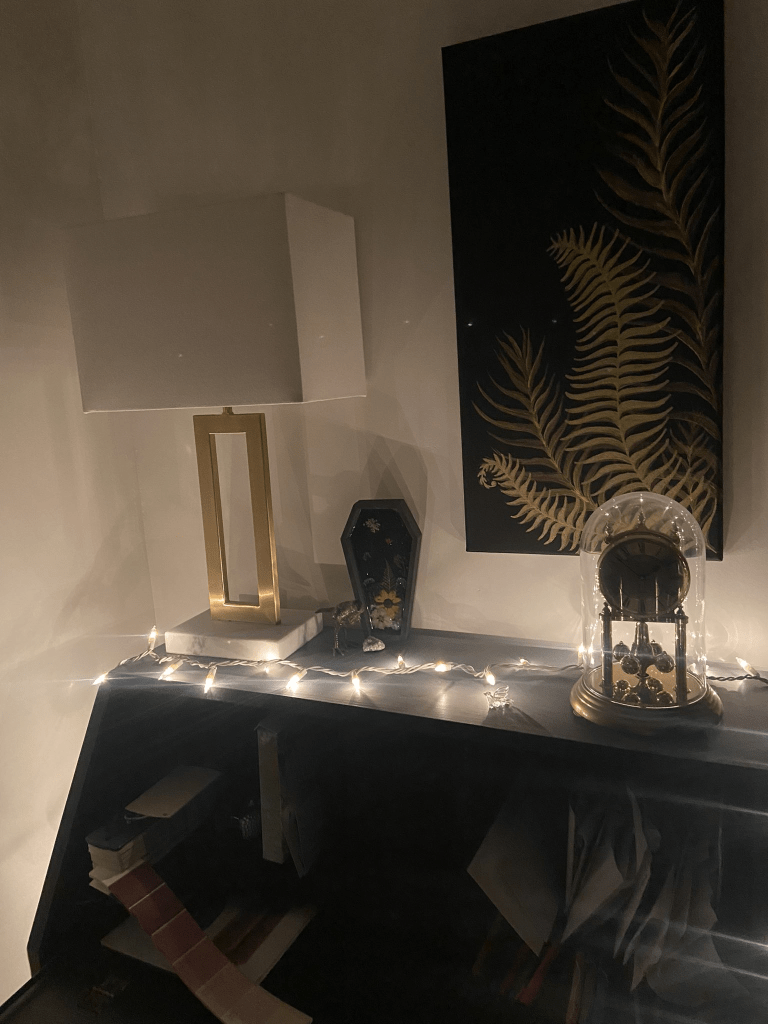 Same desk, now with a string of Christmas lights strewn across the top softly illuminating the space.